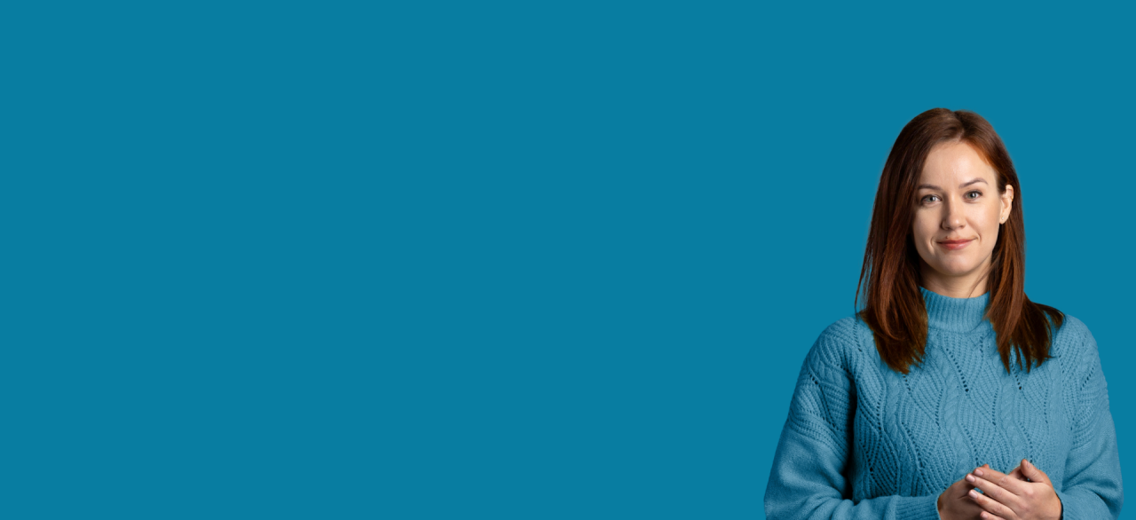 women in blue sweater standing on the blue background