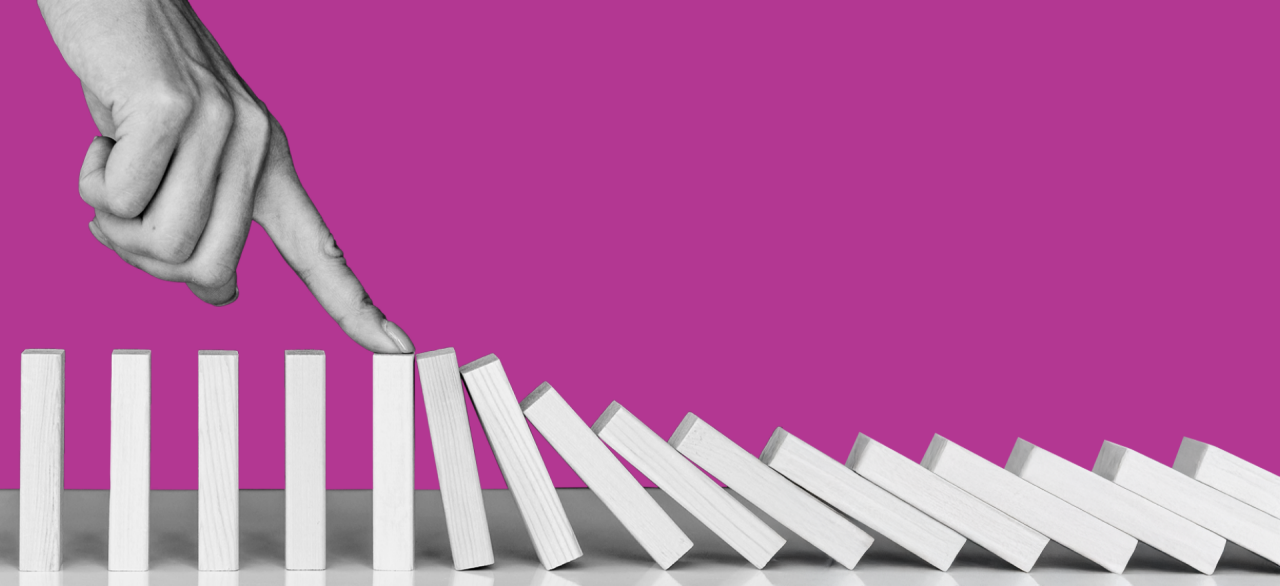 index finger running through dominoes in a line